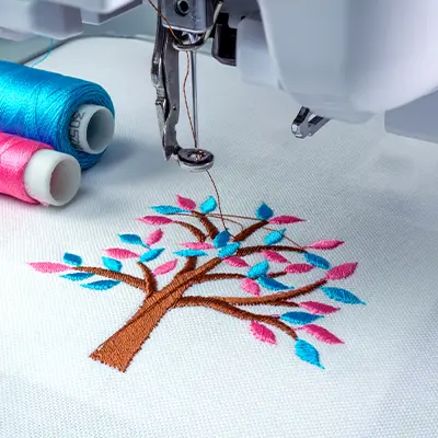 Logo Being Embroidered Using A Sewing Machine